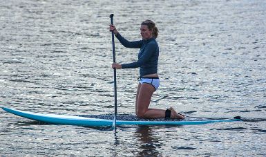 This image of a paddleboarder at Hanalai Bay, Hawaii (she has yet to get to the "stand-up" part) was taken by Frank Kovalchek and is used courtesy of the Creative Commons Attribution 2.0 Generic License.  (http://en.wikipedia.org/wiki/File:Sweet_lass_paddleboarding_(8034634405).jpg)